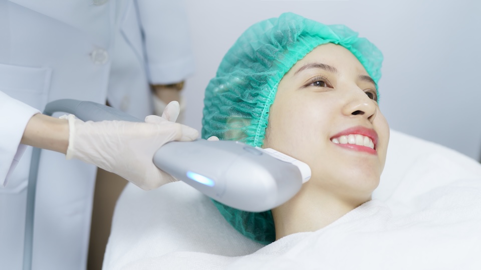 Woman getting Hifu spa treatment, girl receiving ultra former massage face. Anti aging treatment and plastic surgery concept.